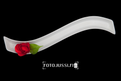 Decorative vase with red fake flower isolated on a black background